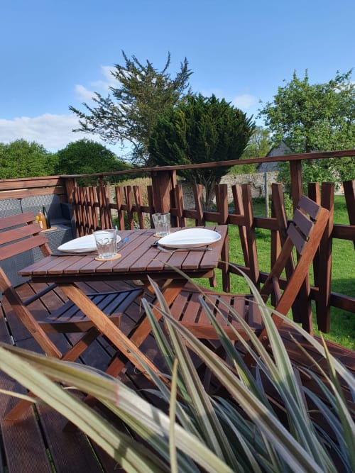 Wooden garden dining set on terrace at Le Clos Des Sources, Isigny-sur-Mer cottage with countryside views
