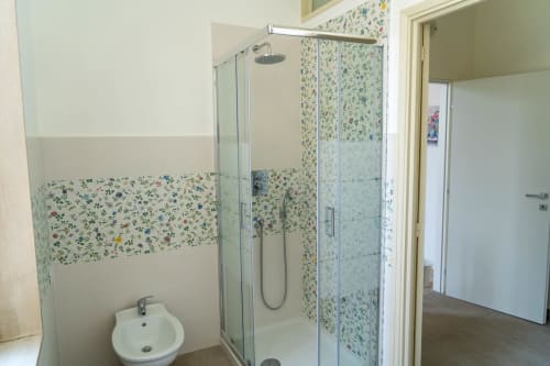 Modern bathroom with floral tile shower enclosure in Sicily In Home apartment, Catania