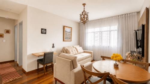 Elegant 2-bedroom apartment at Wellington Rodovalho in Goiânia with cream sofa, wooden dining table, and city views near