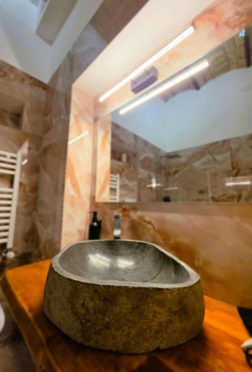 Bagno di lusso moderno al Vatican Nice Holiday di Roma con lavabo in pietra e illuminazione LED contemporanea
