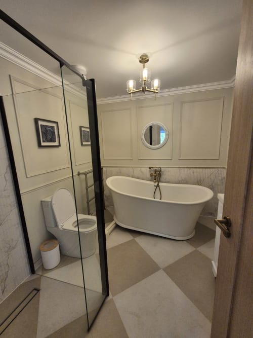 Luxurious bathroom at Rose Vill Homes cottage with freestanding bathtub, walk-in shower, and elegant finishes
