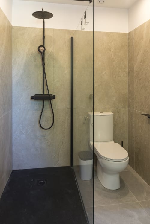 Modern bathroom in Chambre Caducée at Le Clos Saint Maurin B&B, Saint Maurin, featuring rainfall showerhead, glass enclosure,