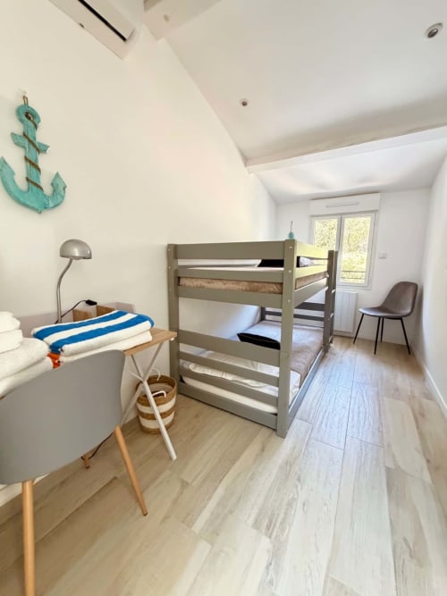 Chambre lumineuse avec lit superposé, bureau et chaise à la Villa Amandine, Les Villas d'A Storia, Porto-Vecchio