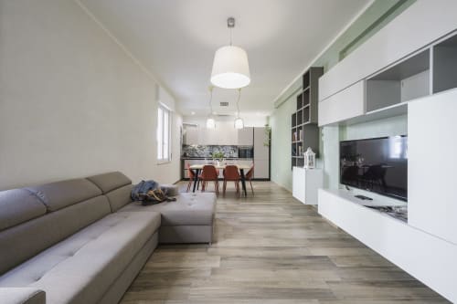 Modern open-plan apartment in Verona with beige sofa, dining area, and kitchen in contemporary design