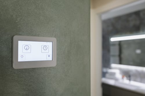 Smart home control panel on green wall in Arena Gateway apartment at STAYIN VERONA hotel in Verona, Italy