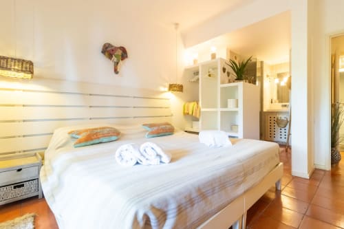 Dormitorio luminoso en Apartamento Sol & Sal de Albufeira con ropa de cama blanca, cojines coloridos y muebles modernos