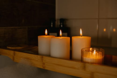 Lit candles in wooden tray at Sable & Pampas bed and breakfast in Carnon-Plage