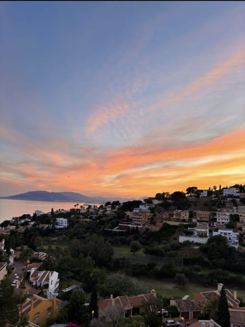 Sunset view over Málaga coastline from Apartamentos Turísticos Axarent with Mediterranean Sea and mountains