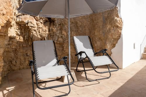 Two loungers with umbrella on terrace at Apartamentos Turísticos Axarent, Málaga