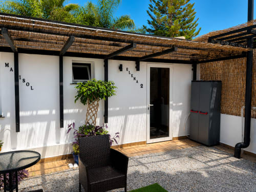 Apartamento 2 Playa Almayate with patio, pergola, potted plants, outdoor seating, and mountain views in Almayate Alto, Spain