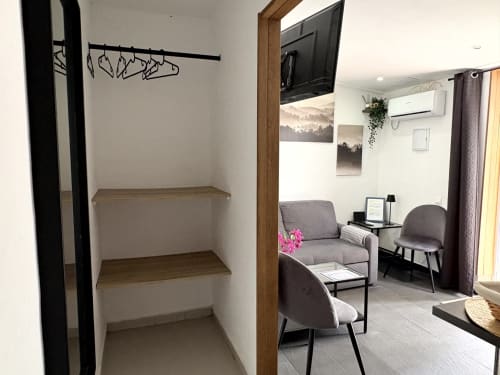 Apartment closet and living room at Axarent Almayate, showing shelving and furnished seating area