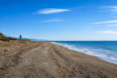 Pebble beach with turquoise sea and mountains, Almayate Alto beachfront apartment view