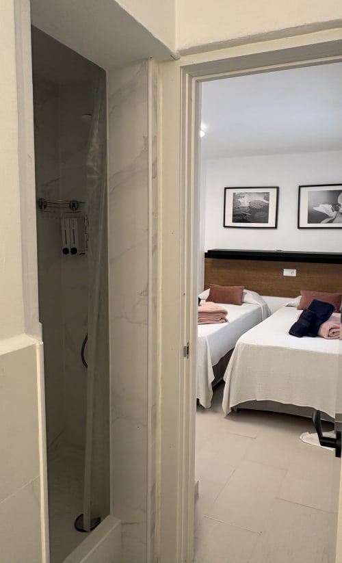 Bedroom with double beds and sea view at Apartamentos Turísticos Axarent, Almayate Alto. Ensuite bathroom visible.