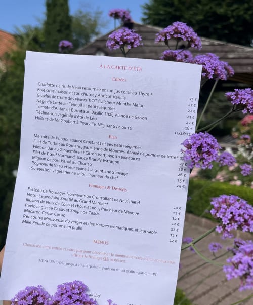 Summer menu at Le Clos Normand, French restaurant in Martin Eglise, displayed with purple flowers