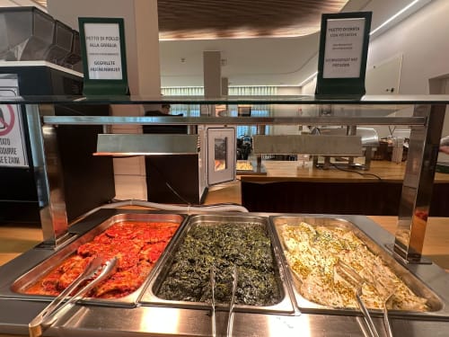 Buffet display at Verdi hotel Jesolo with red sauce, green spinach, and white cream pasta dishes in metal trays