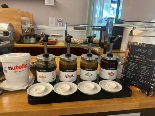 Breakfast spread at Verdi Hotel Jesolo featuring Nutella, jams, and pastries for guests