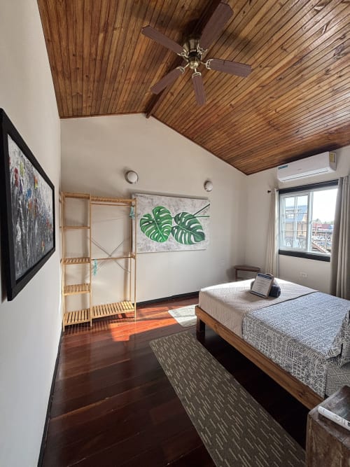 Bright queen bedroom at BarrBra BnB in Bocas del Toro with wooden ceiling, AC, sea view, bed, and modern amenities