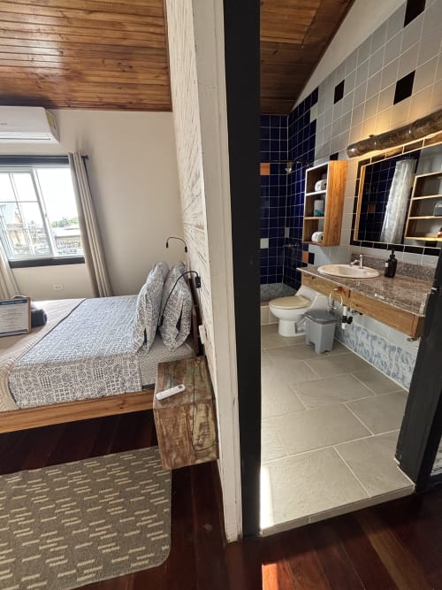 BarrBra BnB Queen Room in Bocas del Toro with en-suite bathroom, wooden beams, and sea view
