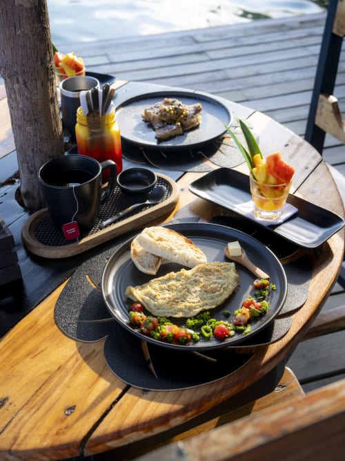 Seaside breakfast at BarrBra BnB: omelet with fresh vegetables, toast, coffee, and tropical drinks overlooking Bocas del Toro