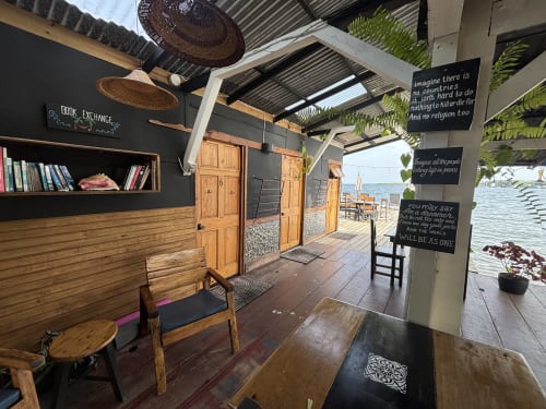 Overwater bungalow interior at BarrBra BnB in Bocas del Toro with wooden furnishings, sea view, and shared facilities
