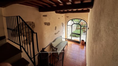 Borgo di Erboli apartment stairway with arched doorway opening to garden patio in Cavriglia