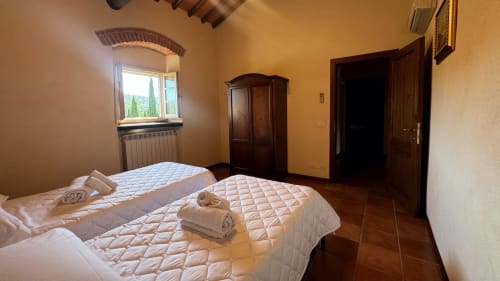 Family apartment at Borgo di Erboli in Cavriglia, Italy with twin beds, terracotta floors and rustic decor