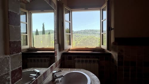 Tuscan countryside view from bathroom windows at Borgo di Erboli, Cavriglia, with cypress trees and rolling hills