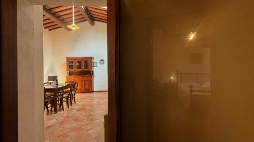 Borgo di Erboli family apartment in Cavriglia with dining area, wooden beams, and rustic furnishings