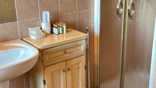 Bathroom in Borgo di Erboli apartment, Cavriglia, with wooden vanity and shower enclosure