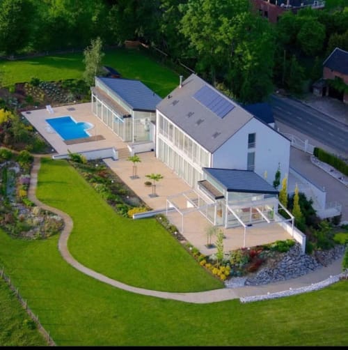 Villa Bianca BnB aerial view with blue pool, modern white architecture, manicured gardens in Mortroux Dalhem, Belgium