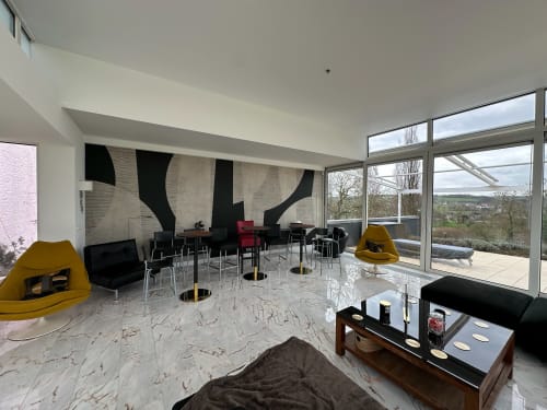 Modern lounge at Villa Bianca B&B in Mortroux Dalhem with marble floors, yellow chairs, and panoramic countryside views