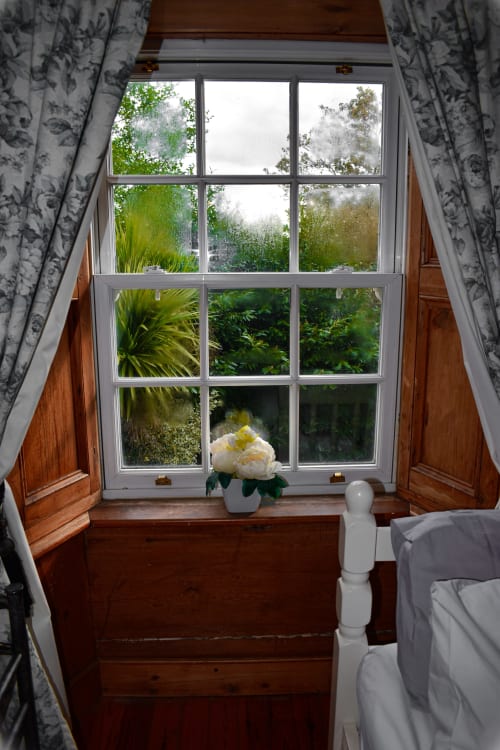 Deluxe Twin Room window at Knockaderry House B&B in Ennis with garden view, white peony flower, wooden sill, patterned