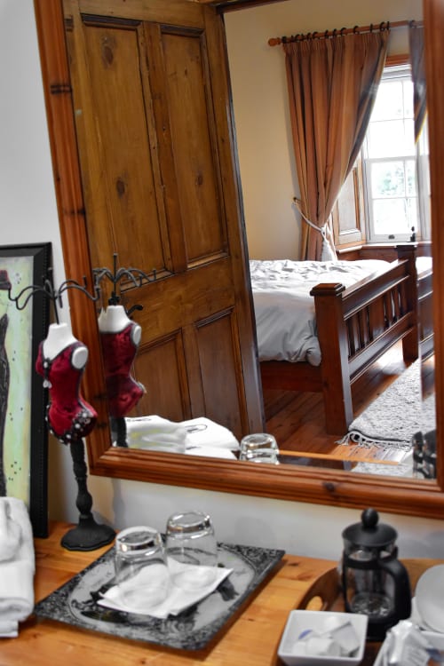 Knockaderry House double room with wooden wardrobe, mirror, and bed visible through doorway, Ennis B&B