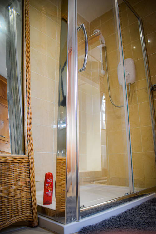 Modern shower enclosure in twin room at Knockaderry House B&B, Ennis with tiled walls and chrome fixtures