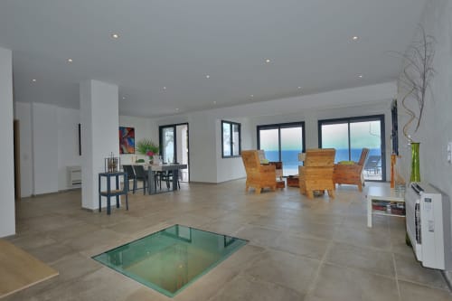 Séjour de la Villa EOLE avec vue mer, mobilier contemporain et disposition ouverte à Centuri, Corse