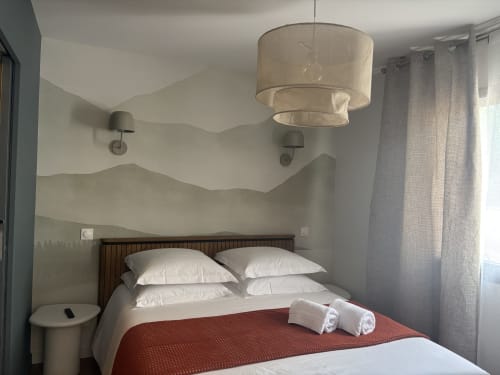 Chambre moderne à la Résidence Les 3 Volcans à Clermont-Ferrand avec mur ondulé, luminaire suspendu et vue sur jardin