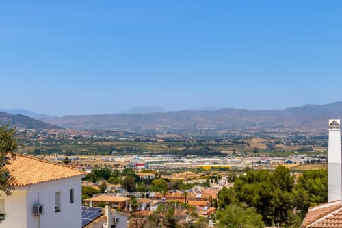 Panoramic view from Ayma Casa Nísperos apartment in Alhaurín de la Torre showing valley, mountains and industrial area below