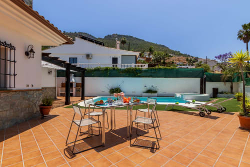 Luxurious pool terrace at Ayma Casa Nísperos in Alhaurín de la Torre with dining area and mountain views