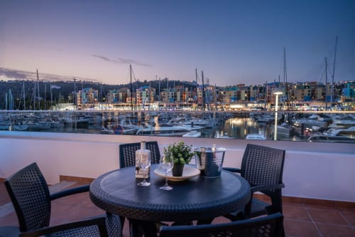 Terraço Villa Odyssey ao anoitecer com vista para a marina de Albufeira, velas e edifícios coloridos, Algarve Portugal