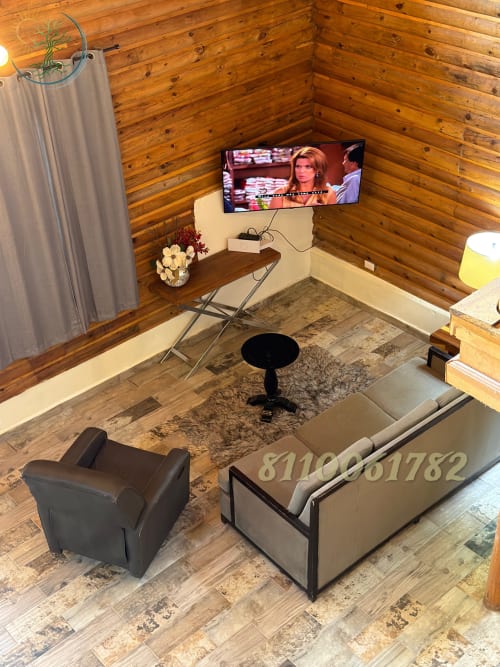 Acogedora cabaña estudio en Tierra Cielo & SoLuna con paredes de madera, TV, sala de estar y vistas a las montañas en Potrero de Serna.