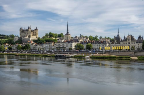 Château de Montsoreau overlooking the Loire River in Oudon, France, with historic architecture and riverside village