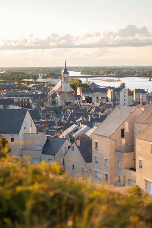 Aerial view of Oudon riverside town with church steeple, historic buildings, and Loire Valley landscape in France