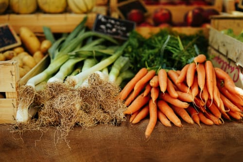 Fresh farmers market produce including carrots and leeks at Chateau Haute Roche in Oudon, France