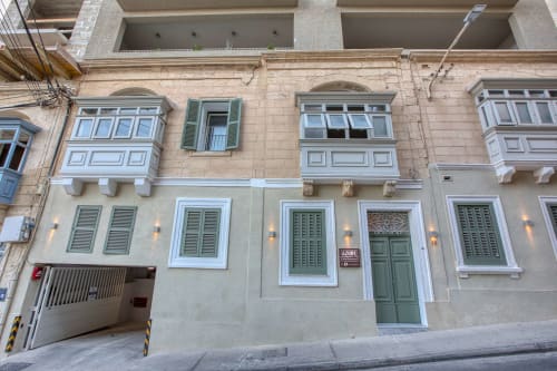 Facciata dell'hotel boutique Marea a Sliema, Malta con finestre con persiane verdi e architettura in pietra