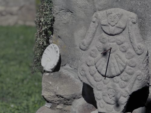 Stone ornamental carving with religious symbols at Albergue Santiago de Caminha hostel in Caminha, Portugal