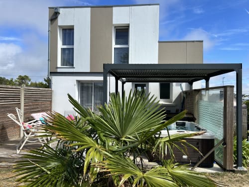 Le Skiff cottage at La Villa Plein Vent with modern architecture, garden terrace, and black pergola in Barneville-Carteret