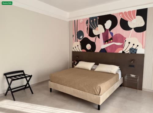 Modern double bedroom at BellDuomo Suite Messina with artistic pink headboard, beige bedding, black luggage stand, and