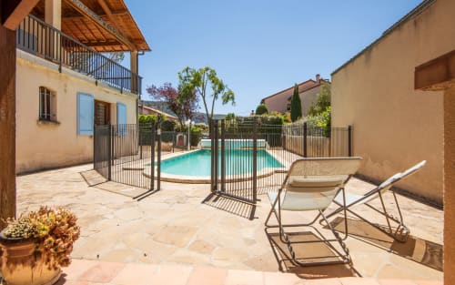 Private pool with loungers at Maison de Louis villa in Millau, France, featuring terrace and fenced courtyard