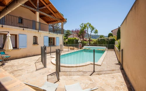 Millau villa with private fenced pool, terrace, and stone patio surrounded by gardens