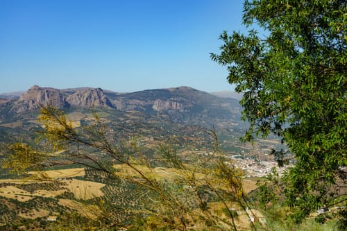 Mountain valley view from Hotel Balcón De Los Montés in Colmenar, Spain with green landscape and distant peaks